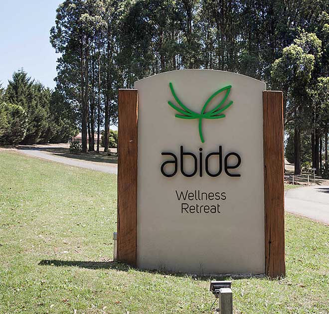 Main entry sign to Abide Wellness retreat designed by M24 Media